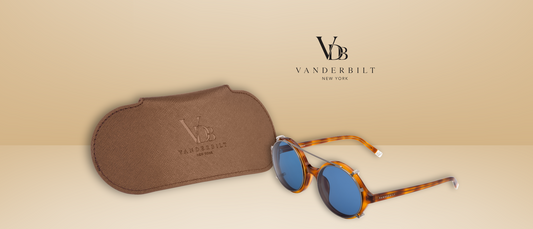 Vanderbilt brown sunglass case displayed next to tortoise shell sunglasses with blue lenses