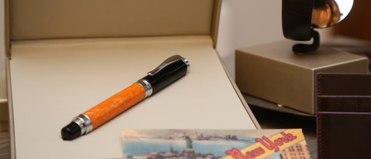 Elegant orange and black luxury pen displayed in a premium box from best luxury pen brands in India