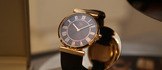 Elegant premium watches for women with black leather strap and gold case displayed on reflective surface