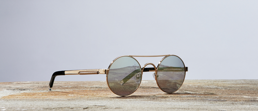 Round Vanderbilt New York sunglasses showcasing the sunglasses and Vanderbilt connection on wooden surface