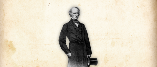 Historical black and white portrait of Vanderbilt standing with a top hat against a vintage background