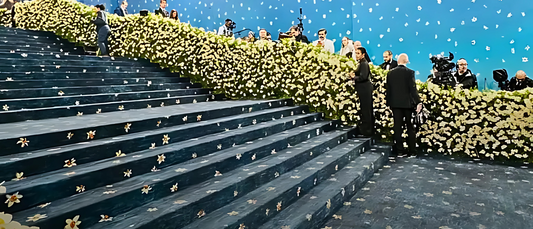 Elegant entrance decorated with white flowers and lights at the Met Gala event